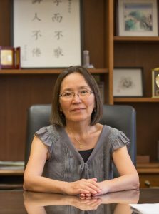 Eave Tsuquiashi sitting at desk.