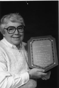 Wilma Cavill holding an APSCUF service award plaque.