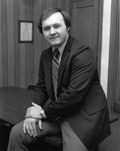 John Hicks sitting on table.