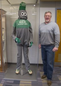 Bob Jones standing by the Rocky the Rock mascot costume.