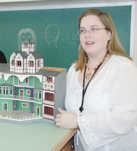 Rebecca Morrice beside miniature model of a playhouse.