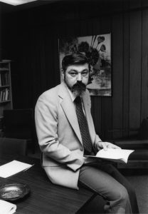 Paul Rizza sitting on a table.