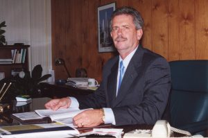 Bruce Russell sitting at a desk.