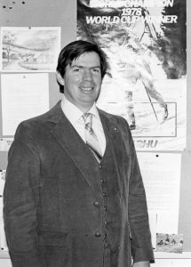 Gary Wakefield standing in front of posters on cork board.